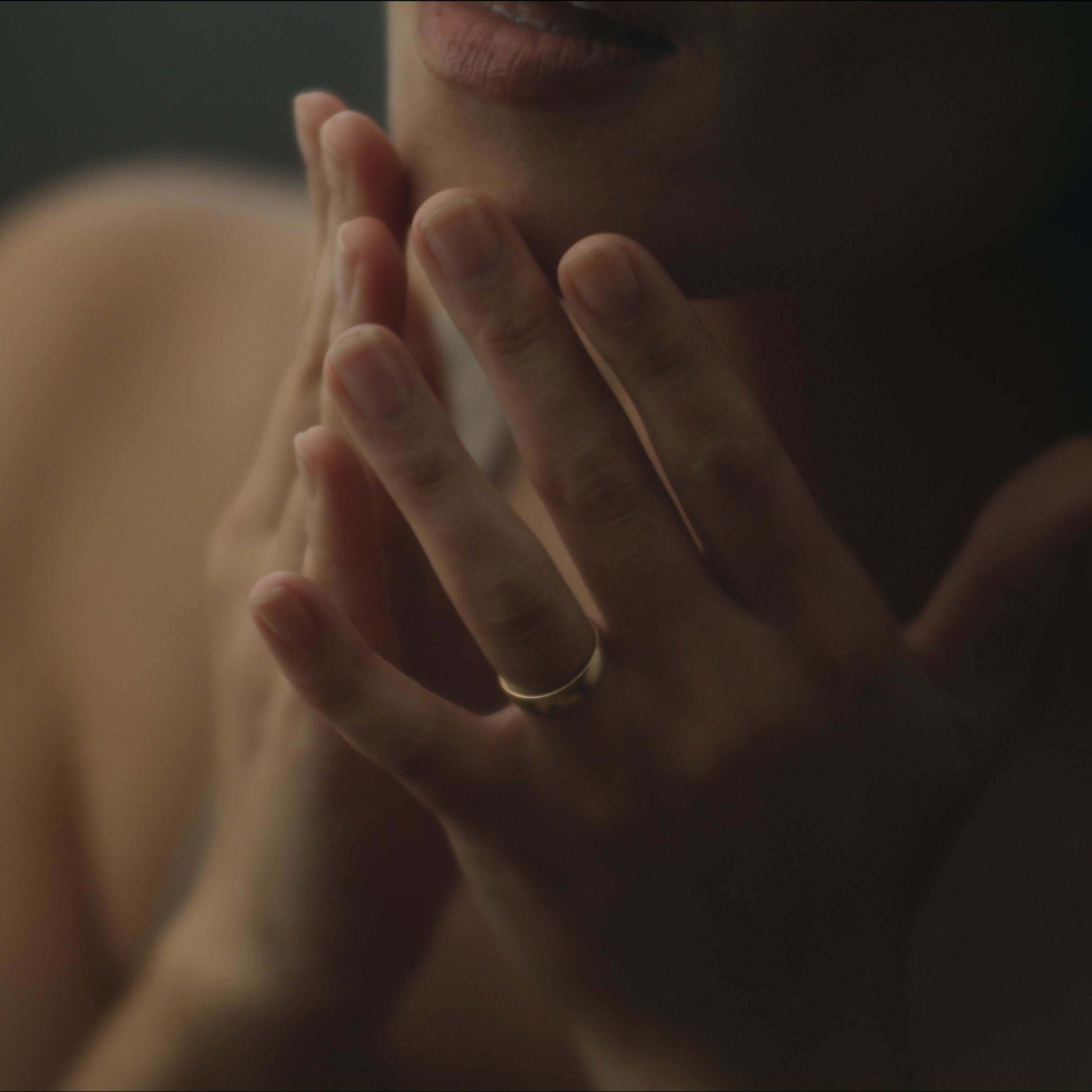 Person wearing a gold ring.